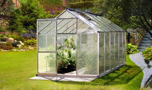 Greenfingers_Brands A Greenfingers greenhouse filled with lush plants.